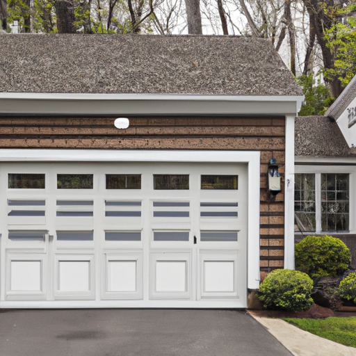 Suburban Haddonfield home exterior with a modern sectional garage door slightly open, driveway and landscaping visible.
